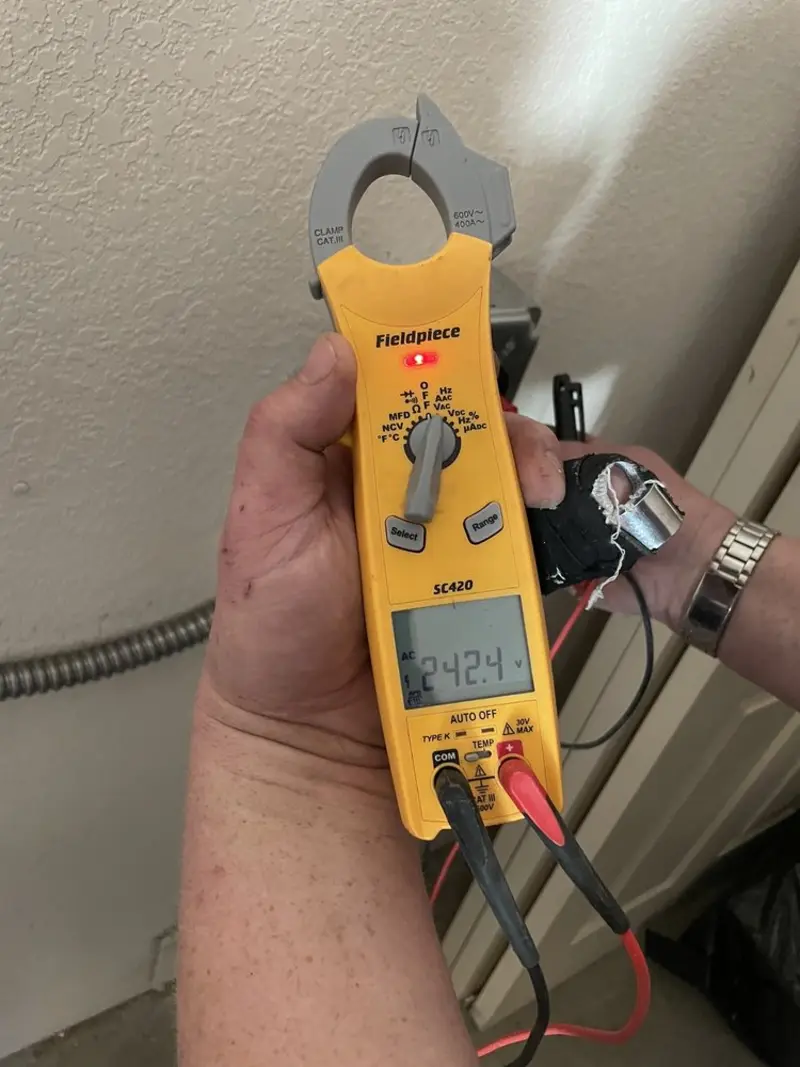 Voltage testing with clamp meter during Recessed Lighting Installation in Coolidge